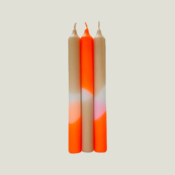 Three candles with gradient colors on a light gray background