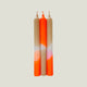 Three candles with gradient colors on a light gray background