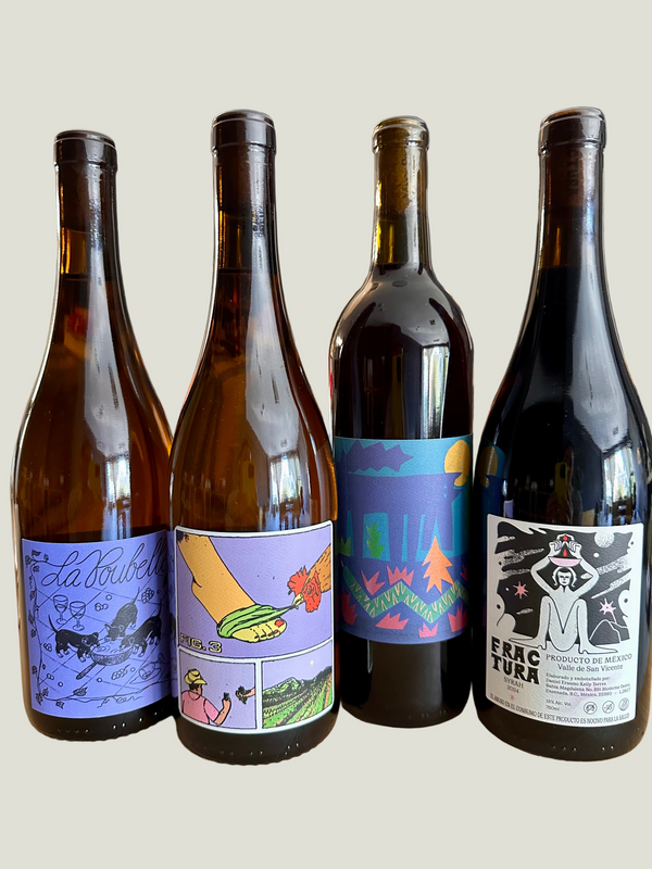 Four wine bottles with colorful labels on a wooden table.
