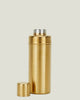 Gold thermos bottle on a beige background