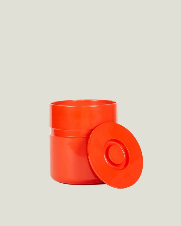 Orange container with lid on a white background