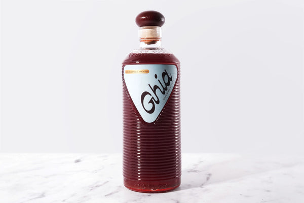 Bottle of Guia on a marble surface with a white background