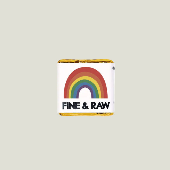 Chocolate bar with rainbow design and 'Fine & Raw' branding on a white background