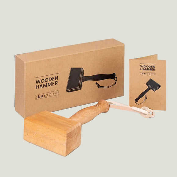 Wooden hammer with packaging on a light gray background