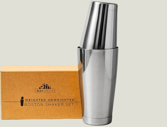 Silver cocktail shaker with wooden box labeled 'Gadget Love' on a white background