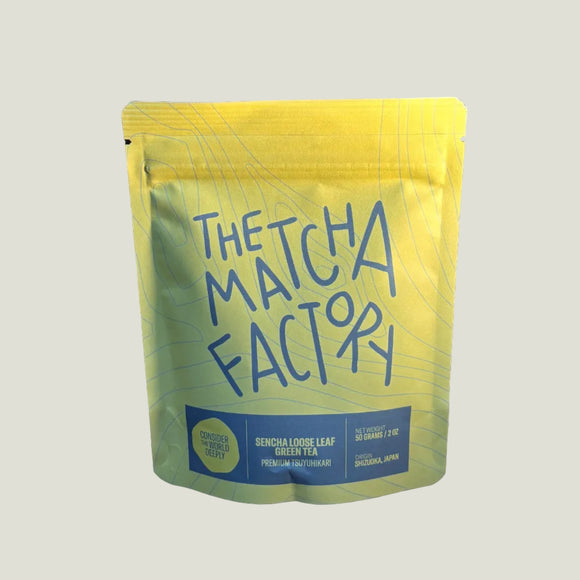Yellow packet of 'The Matcha Factory' on a wooden surface