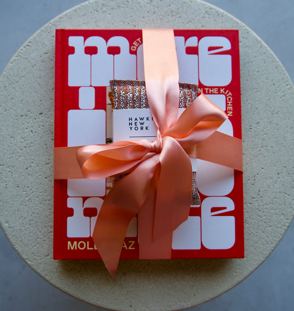 Red box with a pink ribbon on a gray surface