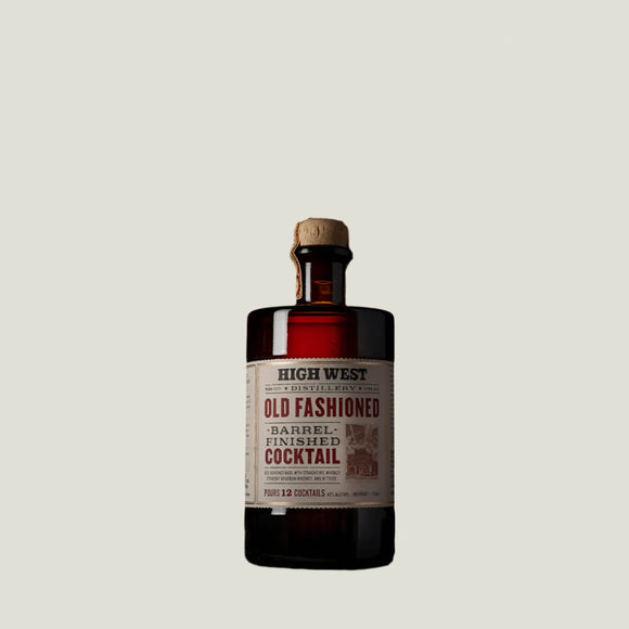 Bottle of High West Old Fashioned Barrel Finished Cocktail on a wooden surface with a brown background
