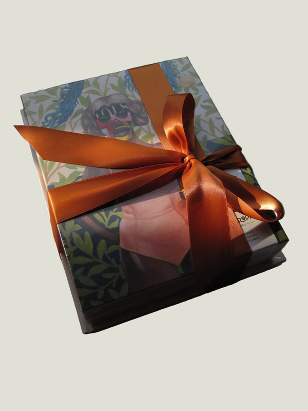 Gift box with an orange ribbon on a textured surface