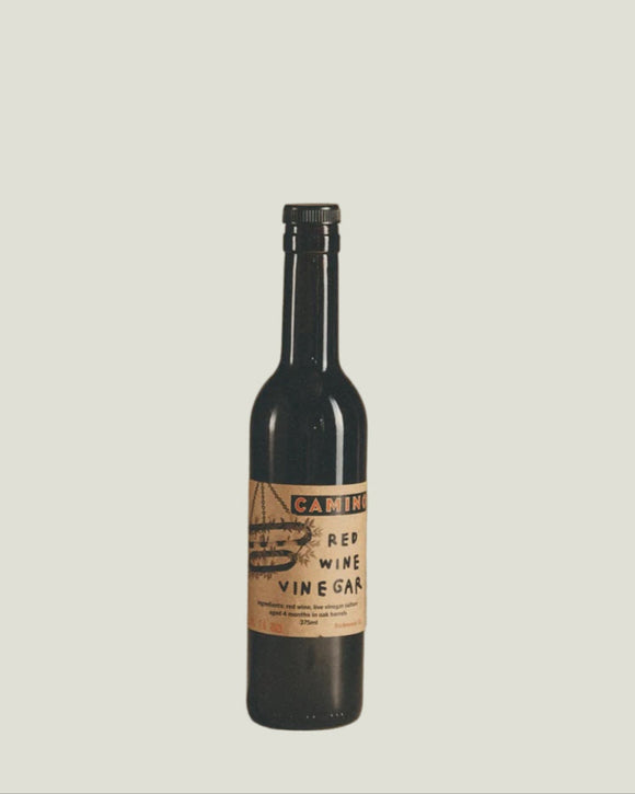 Bottle of wine vinegar with a label on a beige background