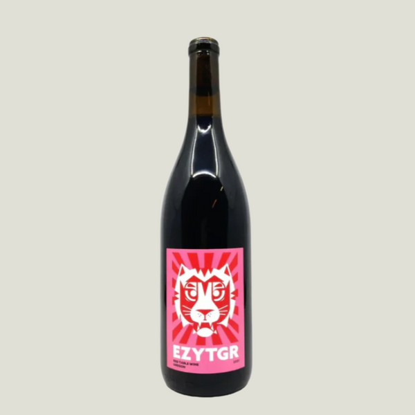 Black wine bottle with a pink label featuring a tiger design on a white background