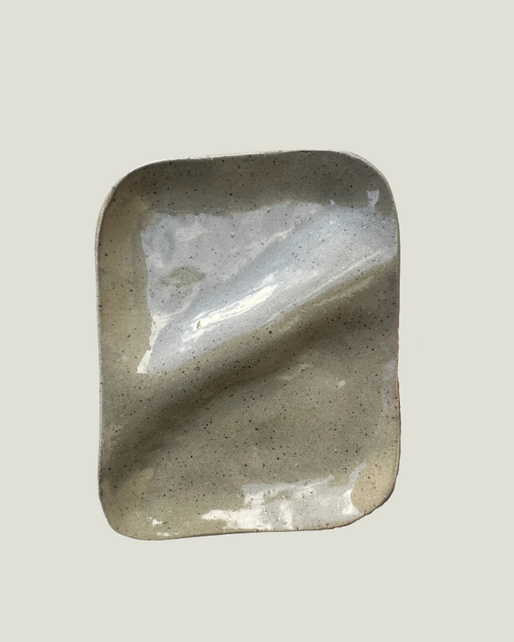 Polished stone with a reflective surface on a light gray background
