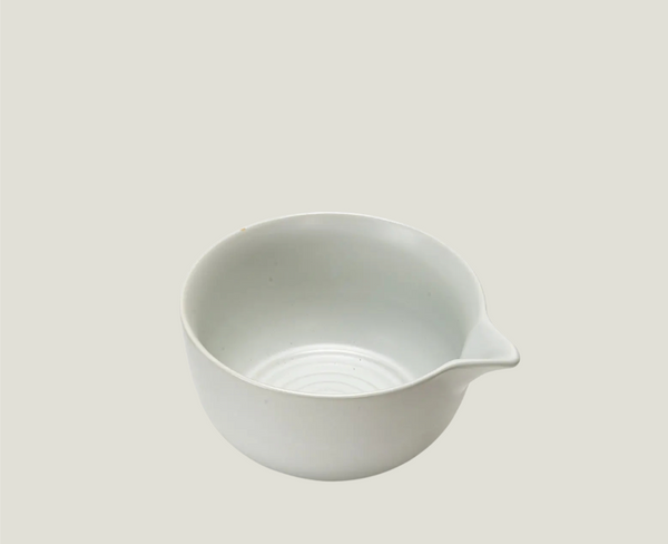 White ceramic pouring bowl on a light gray background