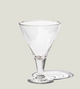 Clear martini glass on a light gray background