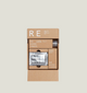 Cardboard packaging of RE SHOE VNR shoe care products on a light gray background