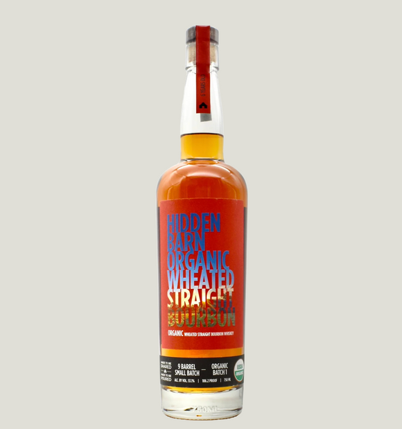 Bottle of Hidden Basin Organic Wheated Straight Rye Whiskey on a light gray background