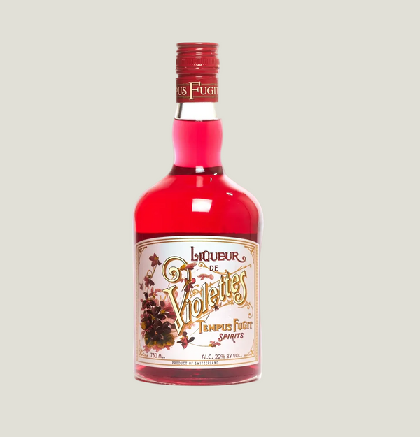 Bottle of Liqueur de Violette with a red label on a white background