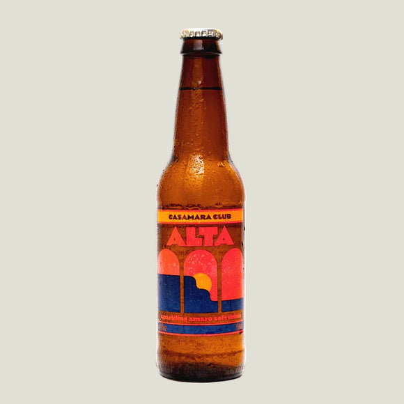Brown beer bottle with colorful label on a beige background