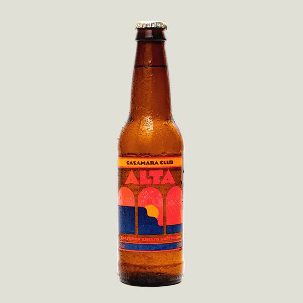 Brown beer bottle with colorful label on a beige background