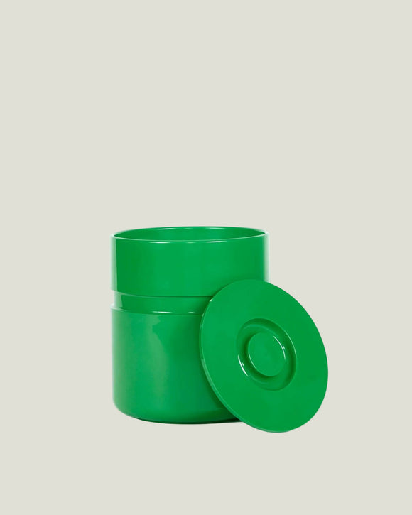 Green plastic container with lid on a white background