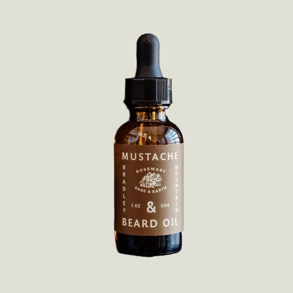 Bottle of Rosemary, Sage, and Earth scented beard oil with brown label by Bradley & Co. on white background.