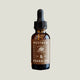 Bottle of Rosemary, Sage, and Earth scented beard oil with brown label by Bradley & Co. on white background.