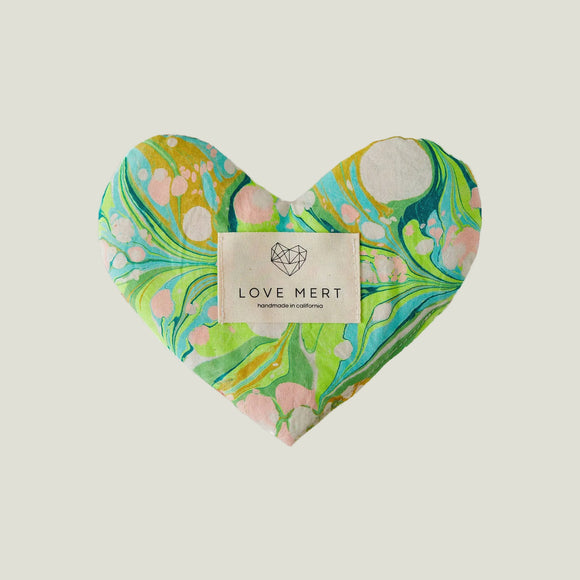 Heart-shaped product with marbled design and 'Love Mert' label on a white background