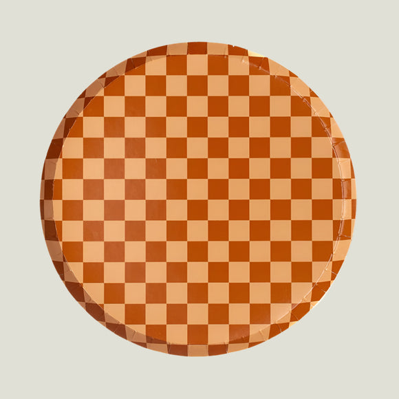 Round paper plate with a brown and beige checkered pattern on a white background