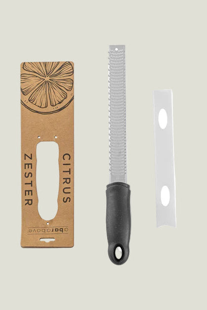 Zester with packaging on a light gray background