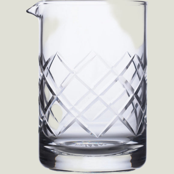 Clear glass pitcher with geometric patterns on a white background
