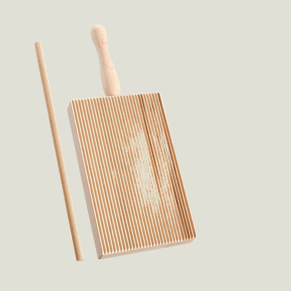Wooden grill brush with a handle on a white background