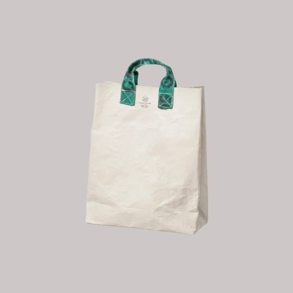 Beige tote bag with green handles on a white background