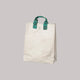 Beige tote bag with green handles on a white background