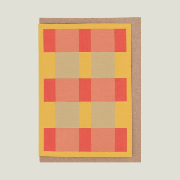 Plaid patterned greeting card with red, yellow, beige squares on a white background