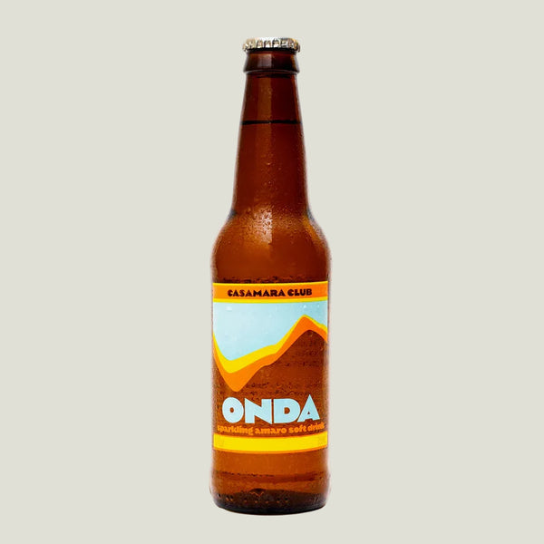 Brown beer bottle with colorful label on a beige background