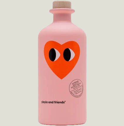 Pink bottle with a red heart logo and 'Comme des Garçons' branding on a white background