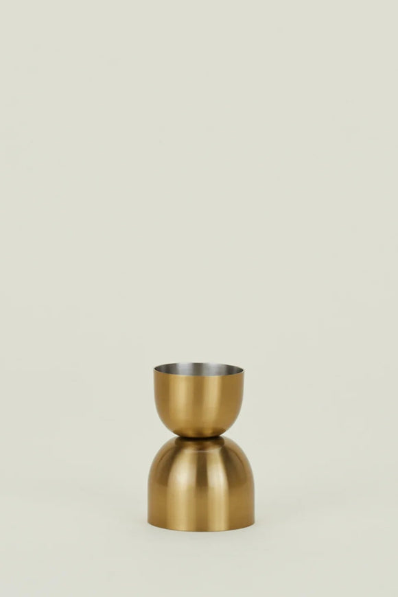 Gold-colored vase on a beige background