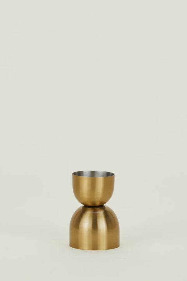 Gold-colored vase on a beige background